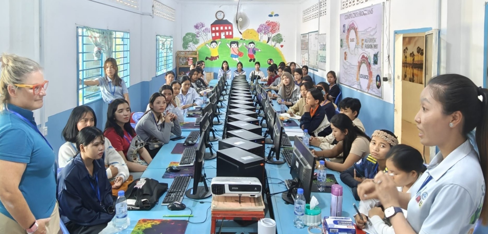 AI literacy workshop at HOPE for Cambodian Children: students at computers